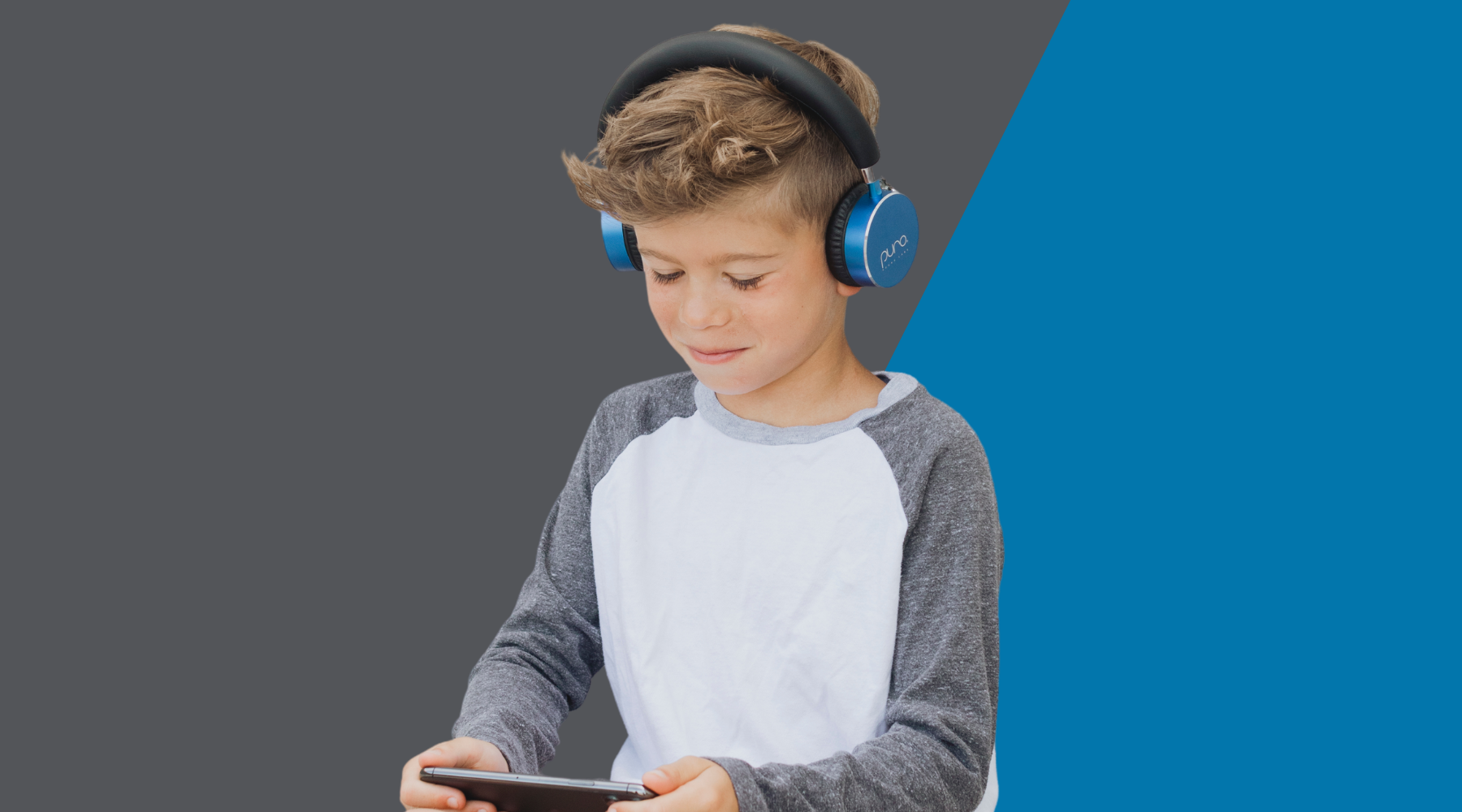 Boy on phone wearing Blue BT2200s Volume Limited Headphones